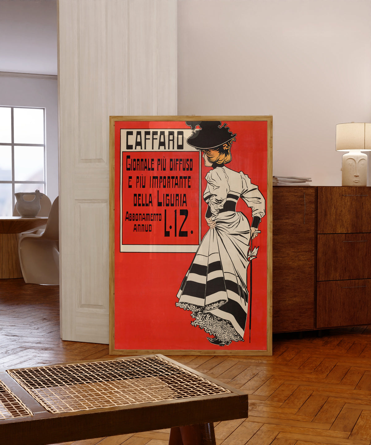 Framed art print of Caffaro: Giornale più Diffuso e più Importante della… by Aleardo Villa, in a light wood frame leaning in a warm room with a parquet floor