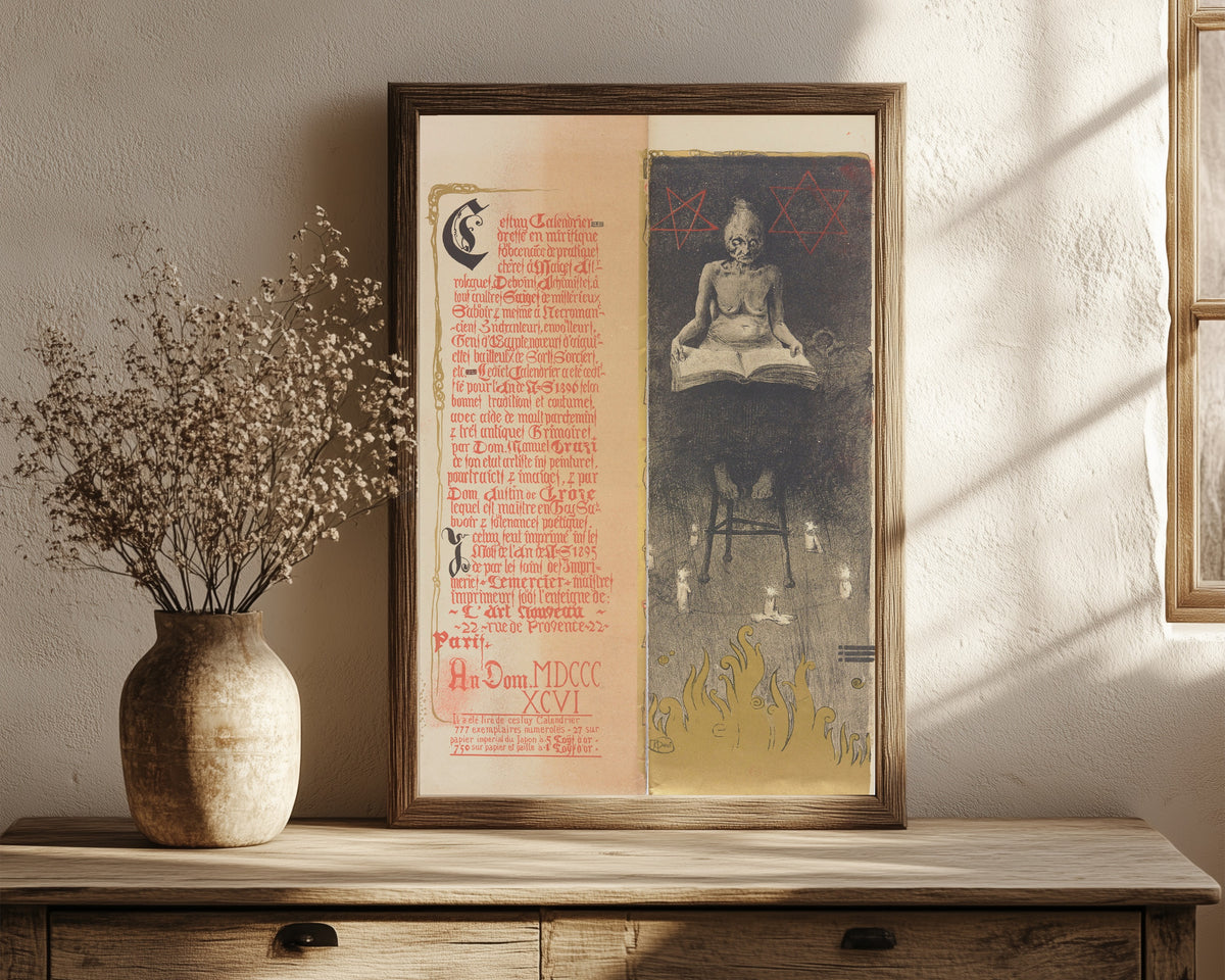 Framed art print of Calendrier magique, Plate 2 by Manuel Orazi, in a dark wood frame leaning on a rustic console beside dried flowers