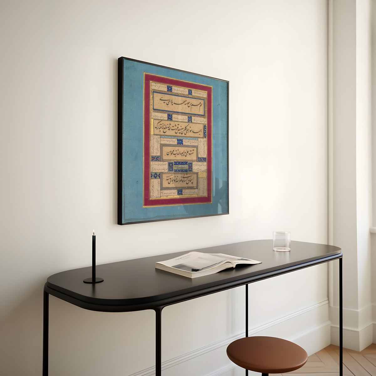 Framed art print of Calligraphic Exercises and Verses of Hafiz by Mahmud ibn Ishaq al-Shahabi, above a slim black console table