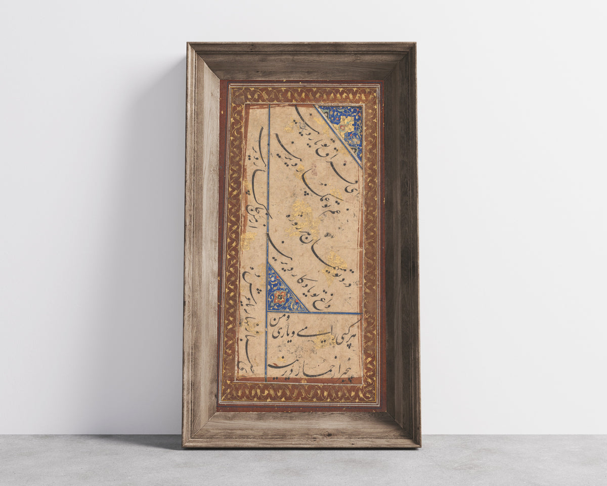 Framed art print of Calligraphy of a Ghazal of Amir Khusrau Dihlavi, in a wide wooden frame leaning against a concrete wall
