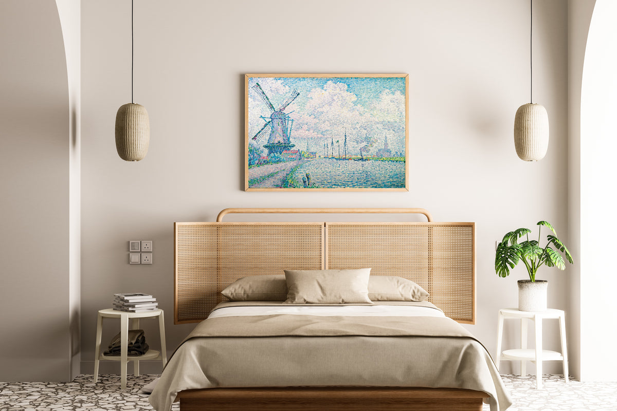Framed art print of Canal of Overschie by Paul Signac, above a cane-headboard bed