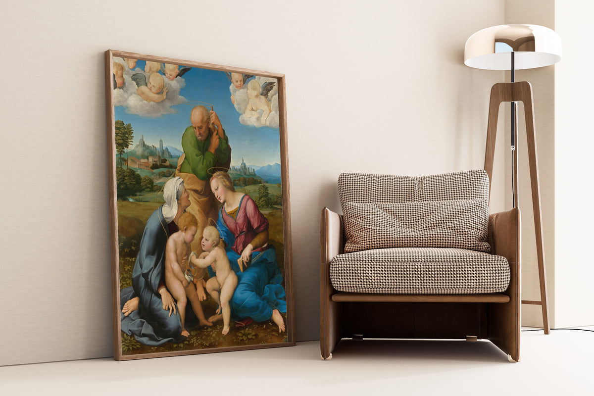 Framed art print of Canigiani Holy Family by Raphael, leaning against a wall beside an armchair and a floor lamp