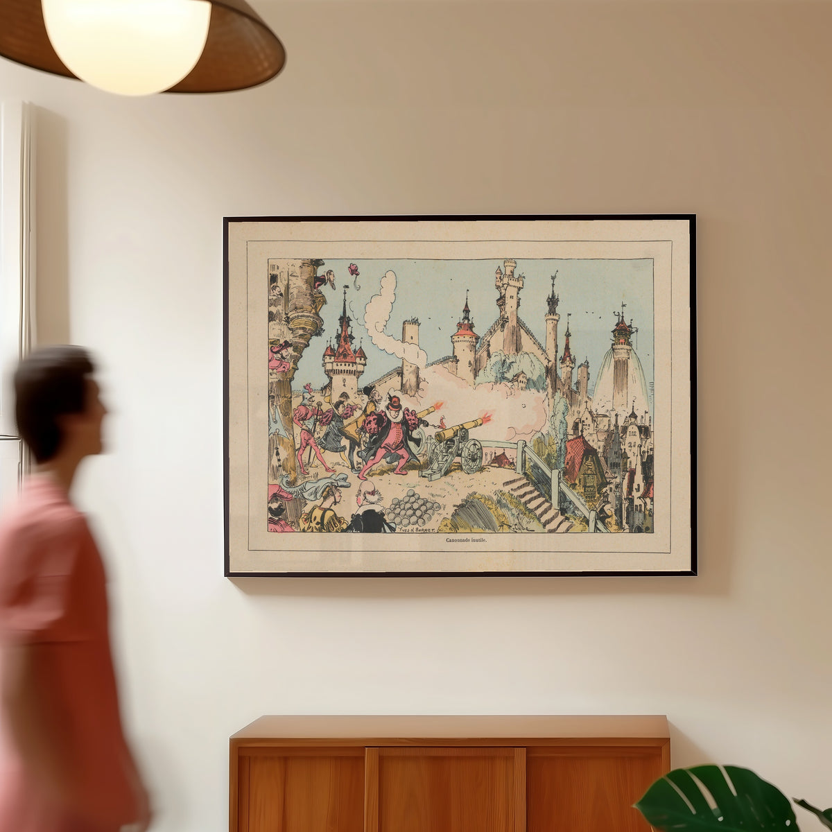 Framed art print of Canonnade inutile by Albert Robida, in a slim black frame on a warm wall in a sunlit room