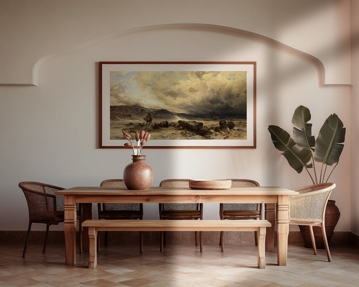 Caravan in a Sandstorm by Hermann Corrodi — framed above a wooden dining table