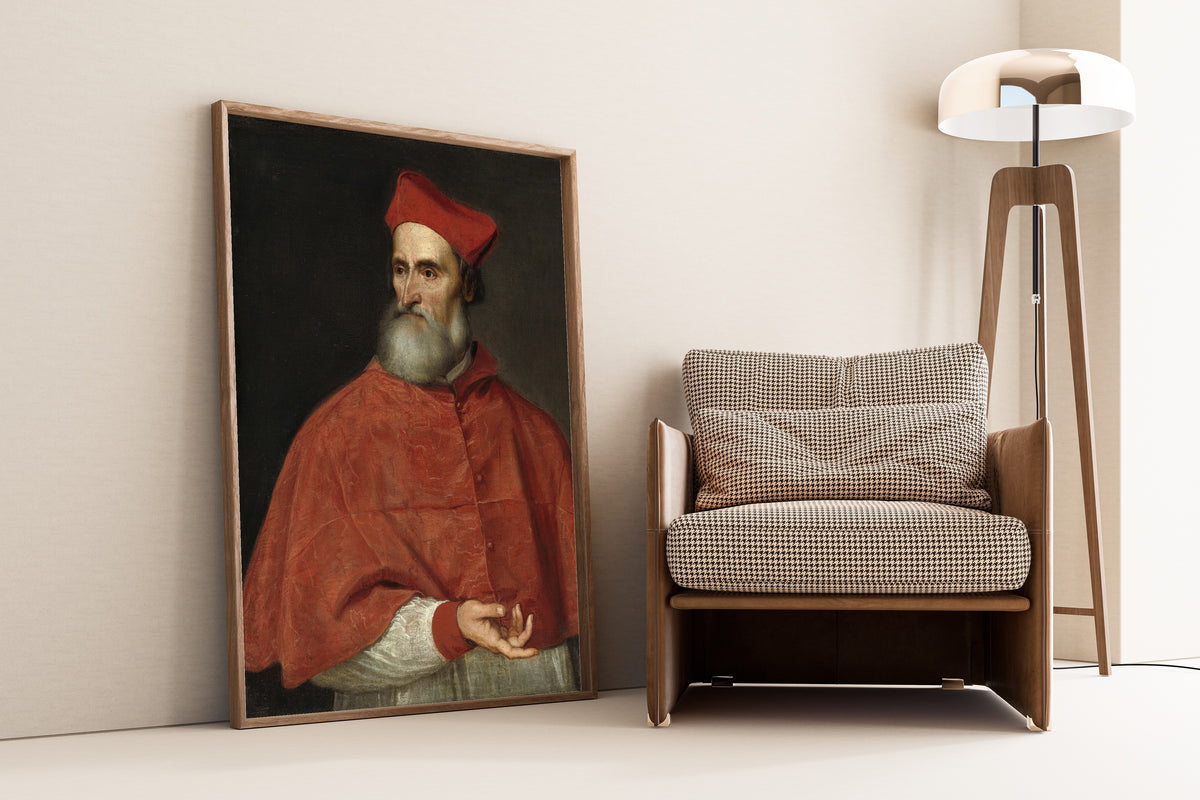 Framed art print of Cardinal Pietro Bembo by Titian, leaning against a wall beside an armchair and a floor lamp