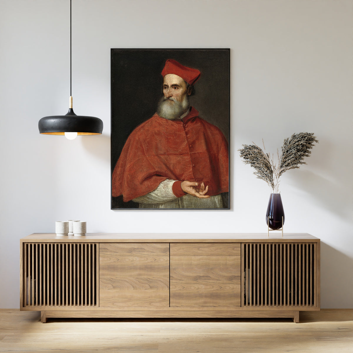 Framed art print of Cardinal Pietro Bembo by Titian, above a slatted wood sideboard