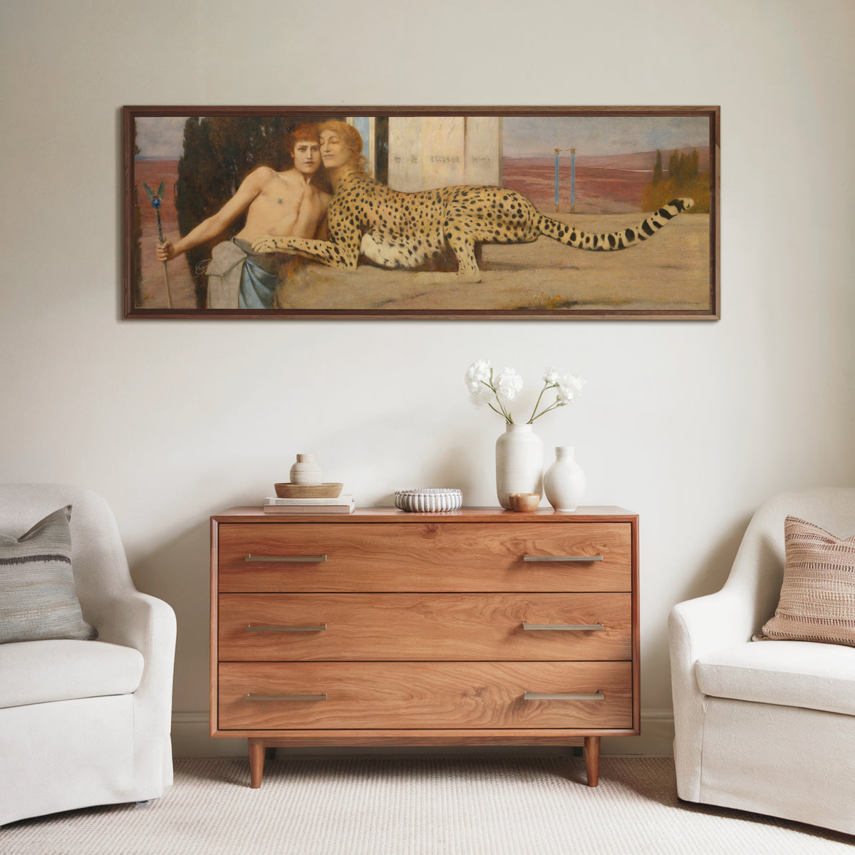 Framed art print of Caresses by Fernand Khnopff, above a wooden chest of drawers