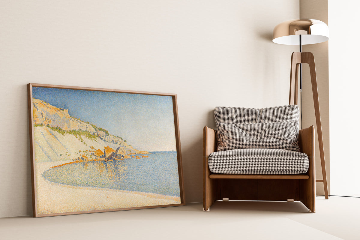 Framed art print of Cassis, Cap Lombard, Opus 196 by Paul Signac, leaning against a wall beside an armchair and a floor lamp