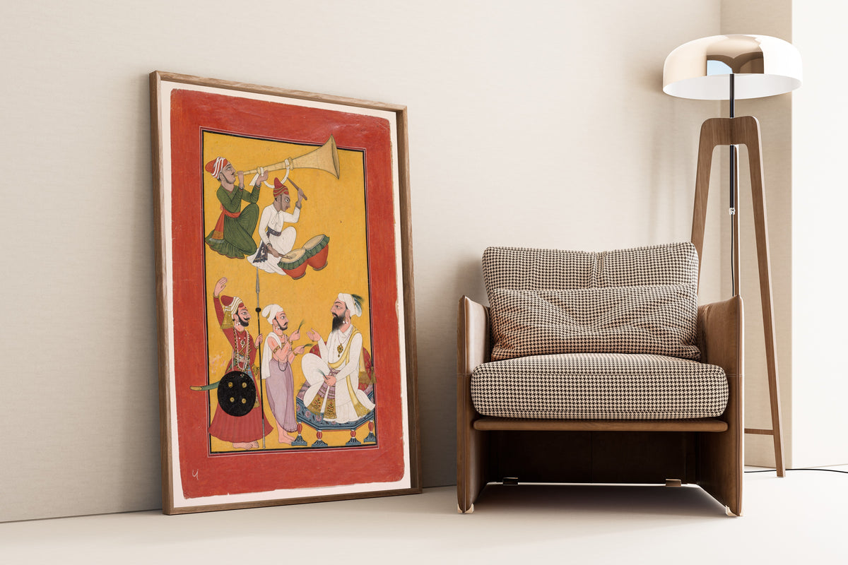 Framed art print of Celebrations of Krishna's Birth, from a Bhagavata Purana by Pahari school, leaning against a wall beside an armchair and a floor lamp