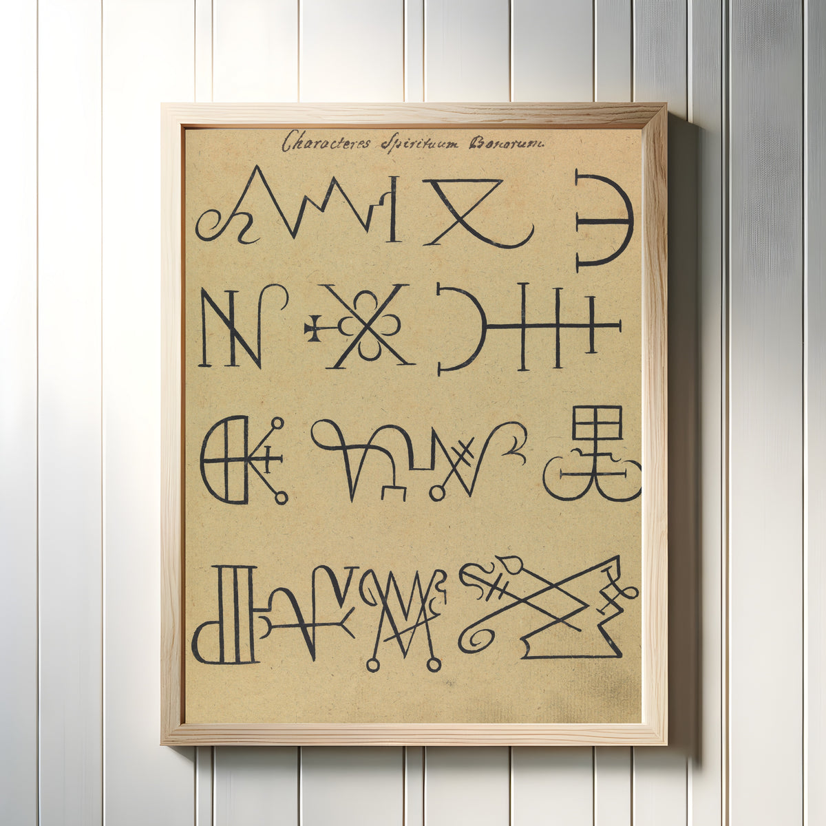 Framed art print of Characteres Spirituum Bonorum by Unknown artist, in a light wood frame on a white panelled wall