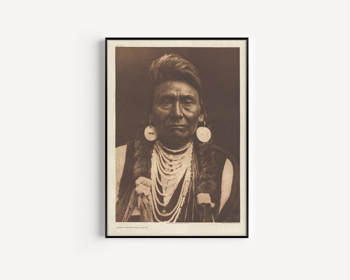 Framed art print of Chief Joseph, Nez Percé by Edward S. Curtis, in a slim black frame on a plain white wall