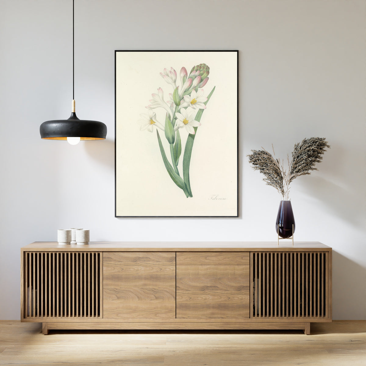 Framed art print of Choix des plus belles fleurs, Plate 107: Tuberosa by Pierre-Joseph Redouté, above a slatted wood sideboard
