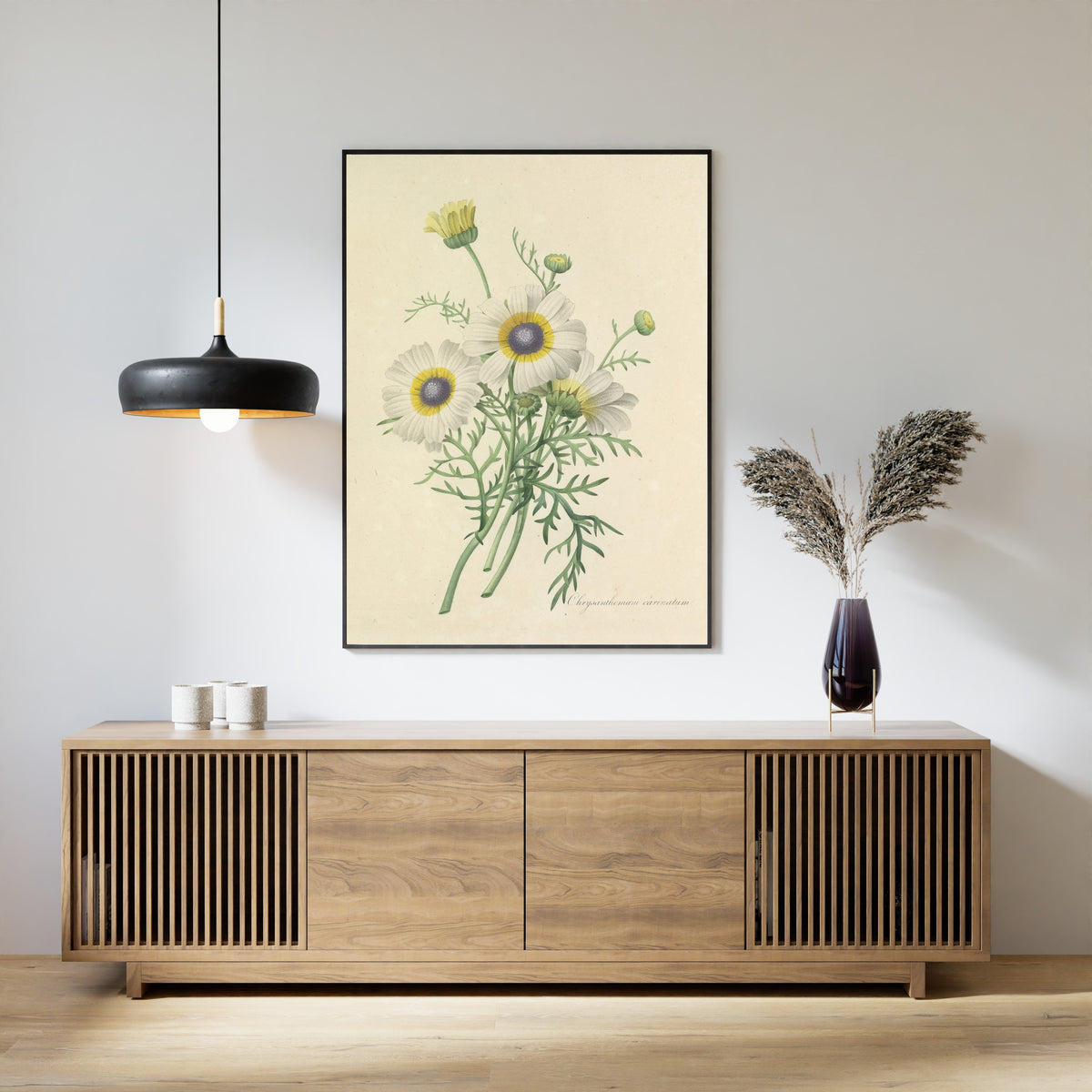 Framed art print of Choix des plus belles fleurs, Plate 24: Chrysanthemum Carinatum by Pierre-Joseph Redouté, above a slatted wood sideboard