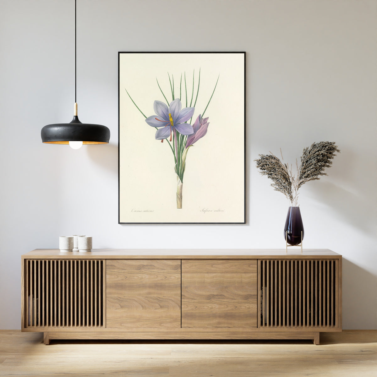 Framed art print of Choix des plus belles fleurs, Plate 28: Crocus Sativus by Pierre-Joseph Redouté, above a slatted wood sideboard