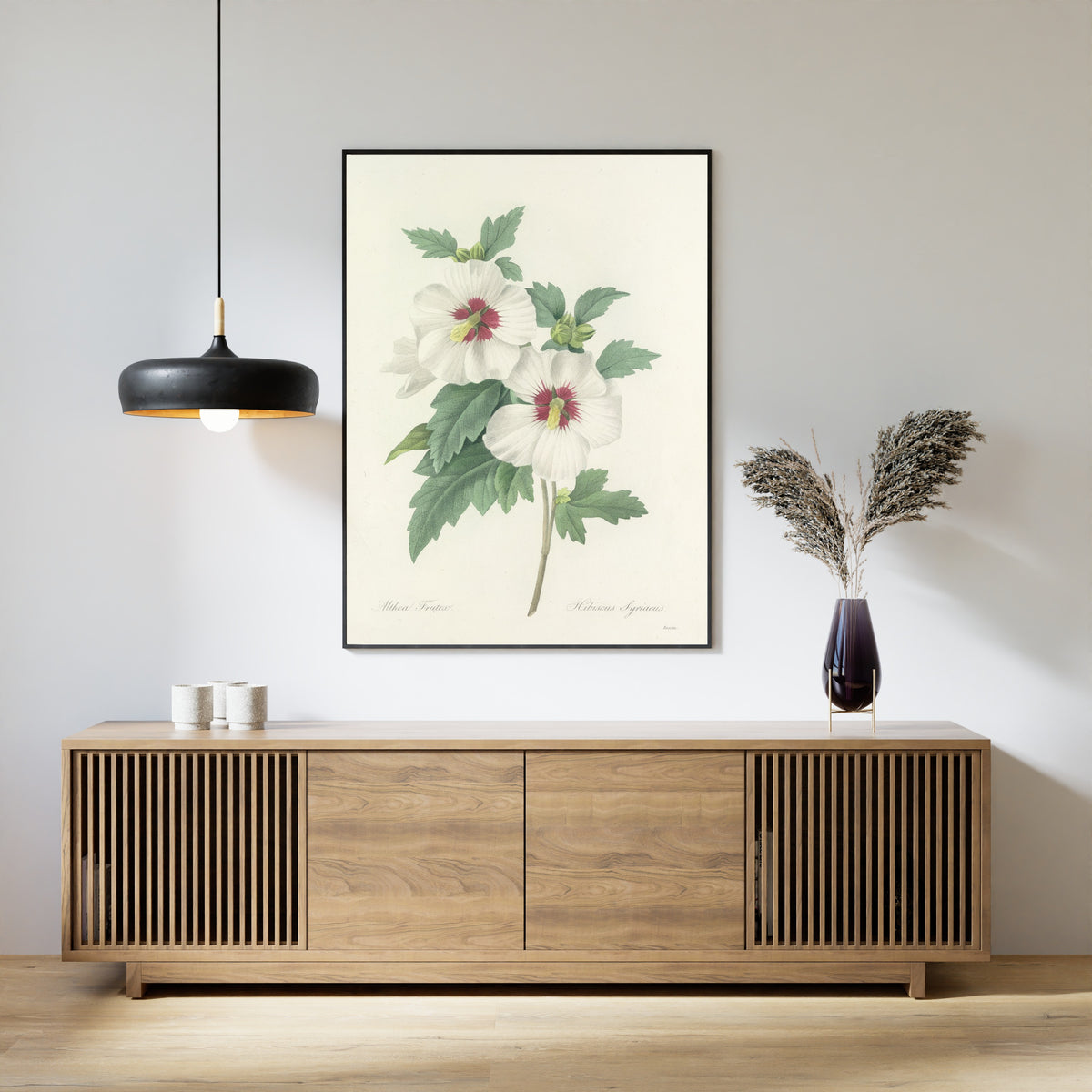 Framed art print of Choix des plus belles fleurs, Plate 4: Hibiscus Syriacus by Pierre-Joseph Redouté, above a slatted wood sideboard