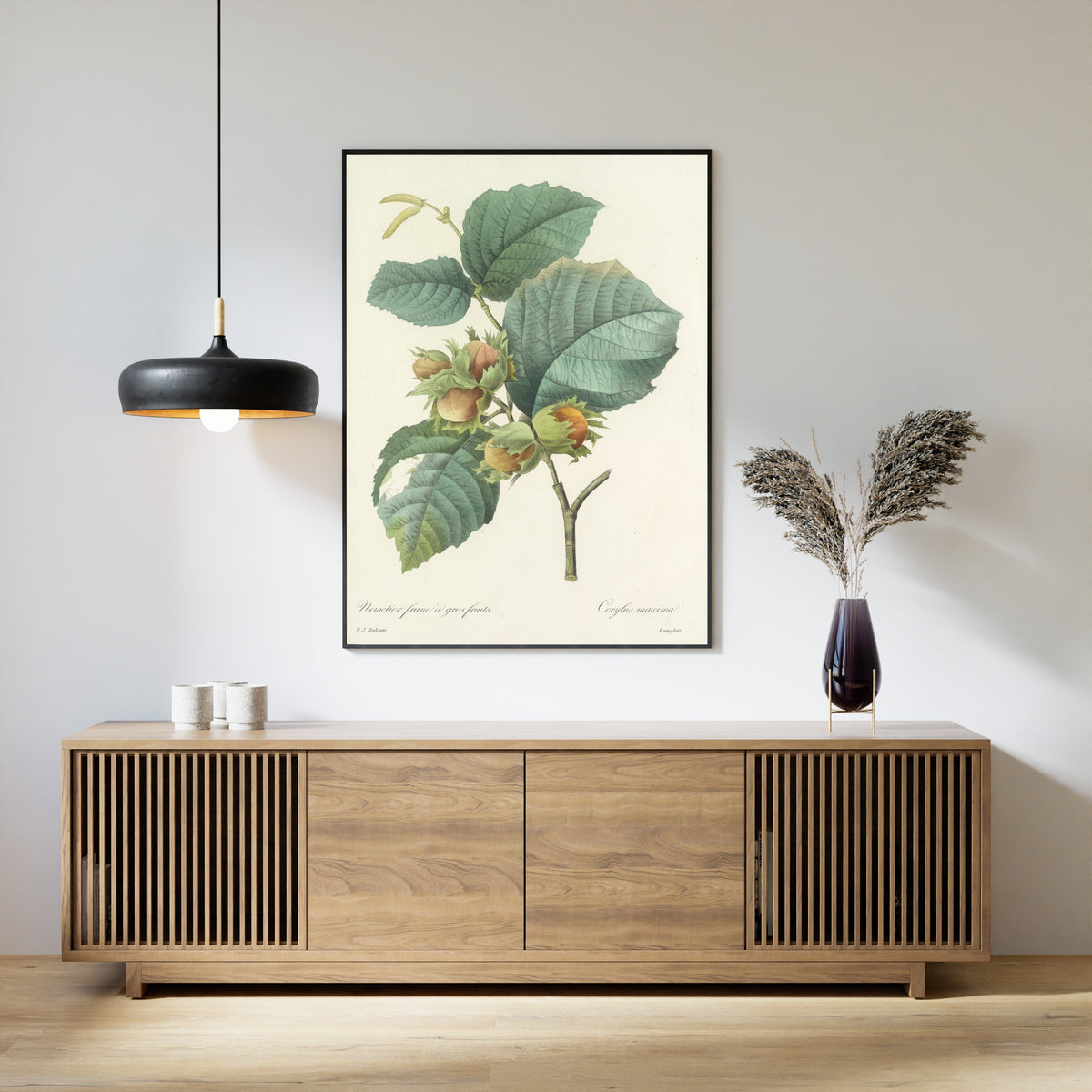 Framed art print of Choix des plus belles fleurs, Plate 54: Corylus Maxima by Pierre-Joseph Redouté, above a slatted wood sideboard