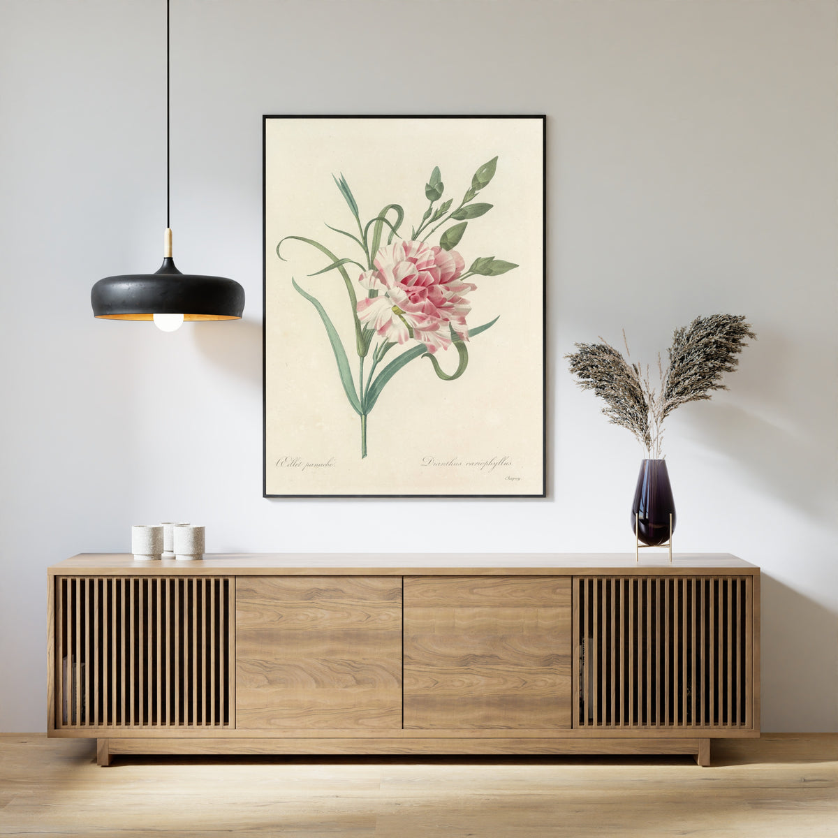 Framed art print of Choix des plus belles fleurs, Plate 56: Dianthus Cariophyllus by Pierre-Joseph Redouté, above a slatted wood sideboard