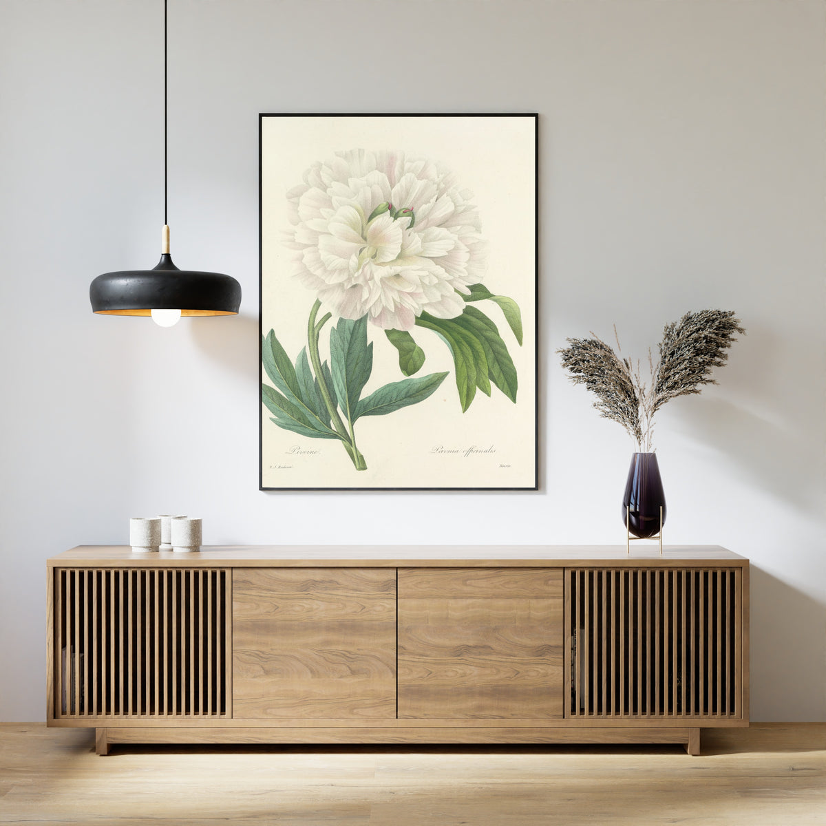Framed art print of Choix des plus belles fleurs, Plate 72: Paeonia Officinalis by Pierre-Joseph Redouté, above a slatted wood sideboard