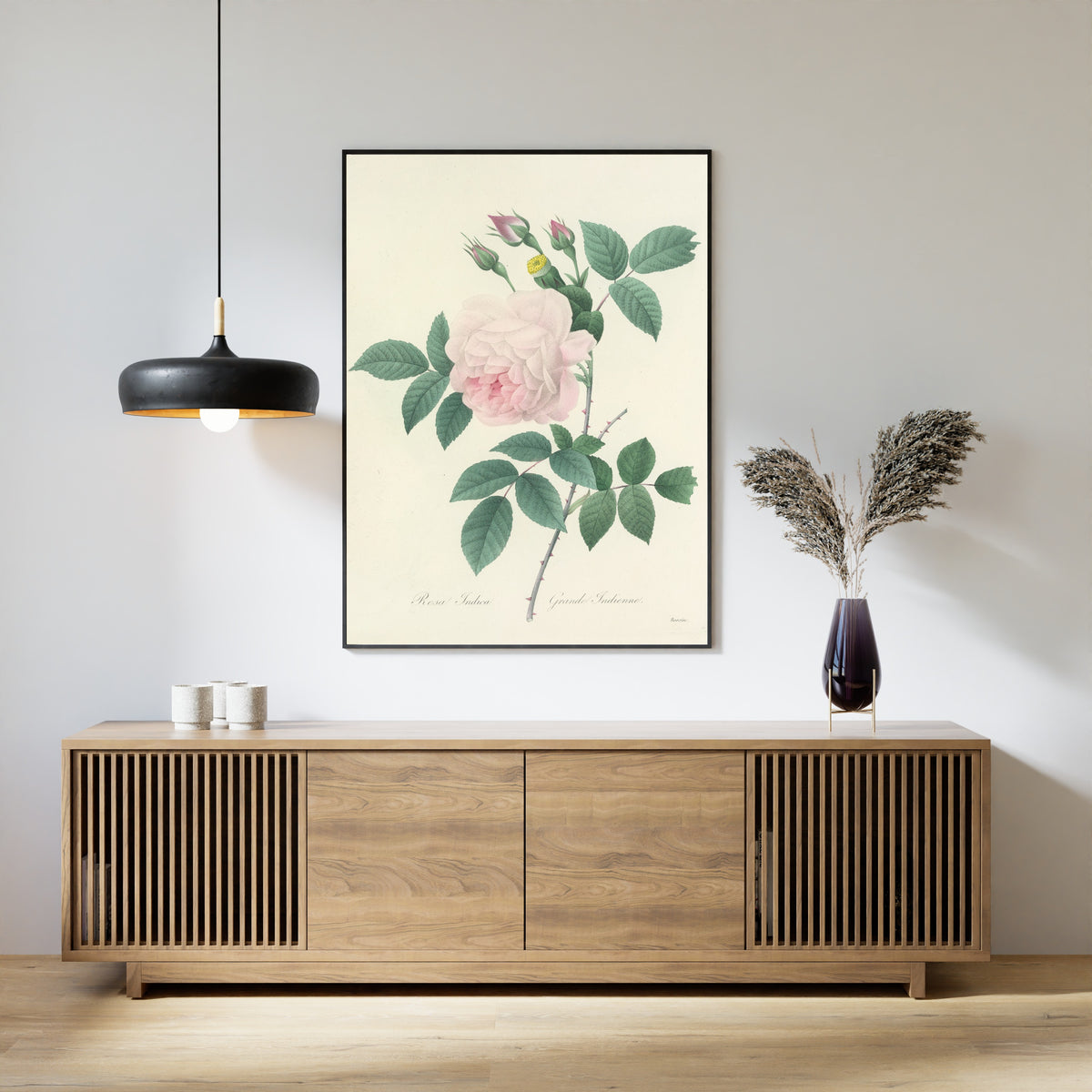 Framed art print of Choix des plus belles fleurs, Plate 91: Rosa Indica by Pierre-Joseph Redouté, above a slatted wood sideboard