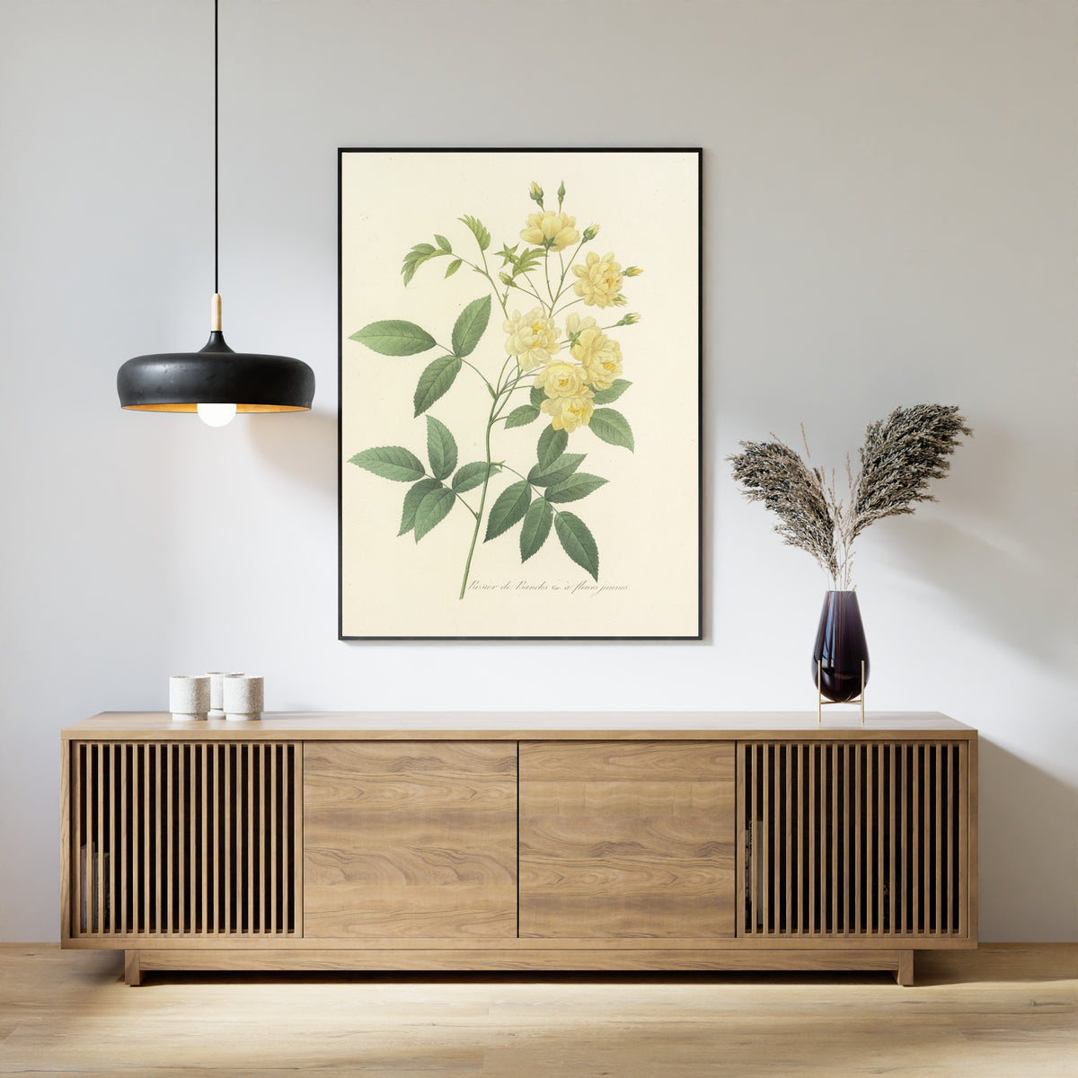 Framed art print of Choix des plus belles fleurs, Plate 97: Rosier de Bancks, Var. à Fleurs Jaunes by Pierre-Joseph Redouté, above a slatted wood sideboard