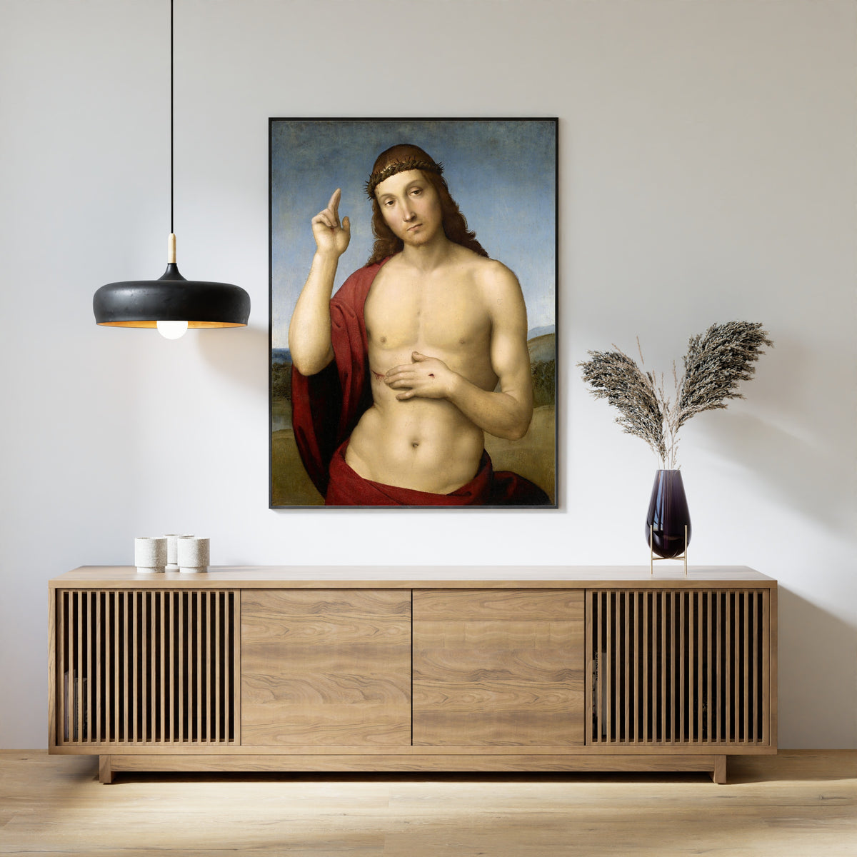 Framed art print of Christ Blessing (Pax Vobiscum) by Raphael, above a slatted wood sideboard