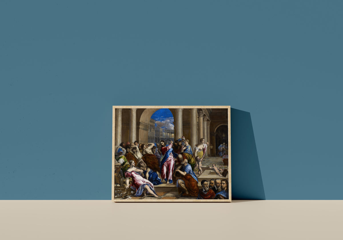 Framed art print of Christ Driving the Money Changers from the Temple by El Greco, in a light wood frame leaning on a blue wall