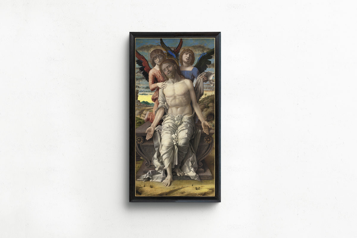 Framed art print of Christ as the Suffering Redeemer by Andrea Mantegna, in a slim black frame on a plain white wall