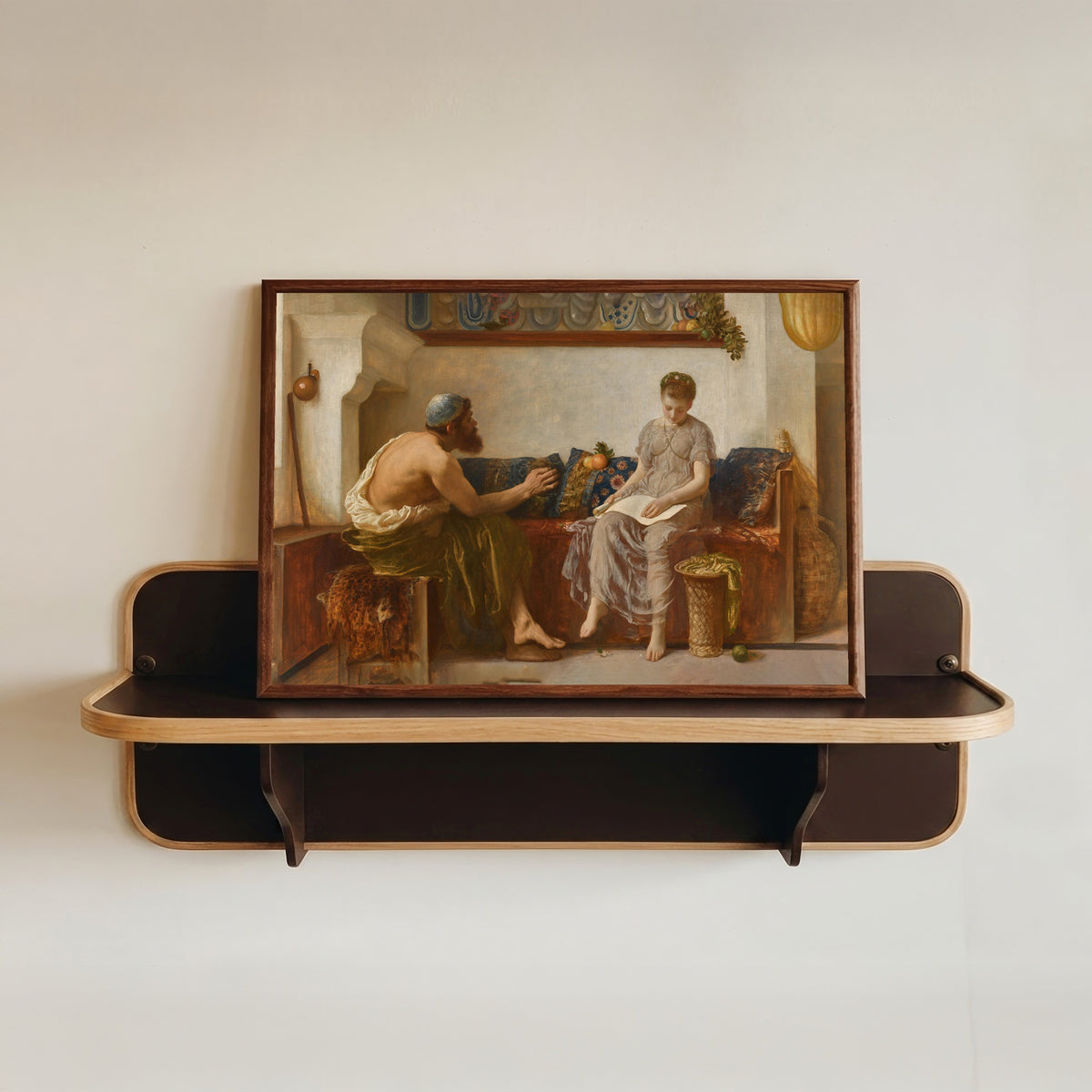 Framed art print of Cleoboulos Instructing his Daughter Cleobouline by Frederic Leighton, in a dark wood frame resting on a wall shelf