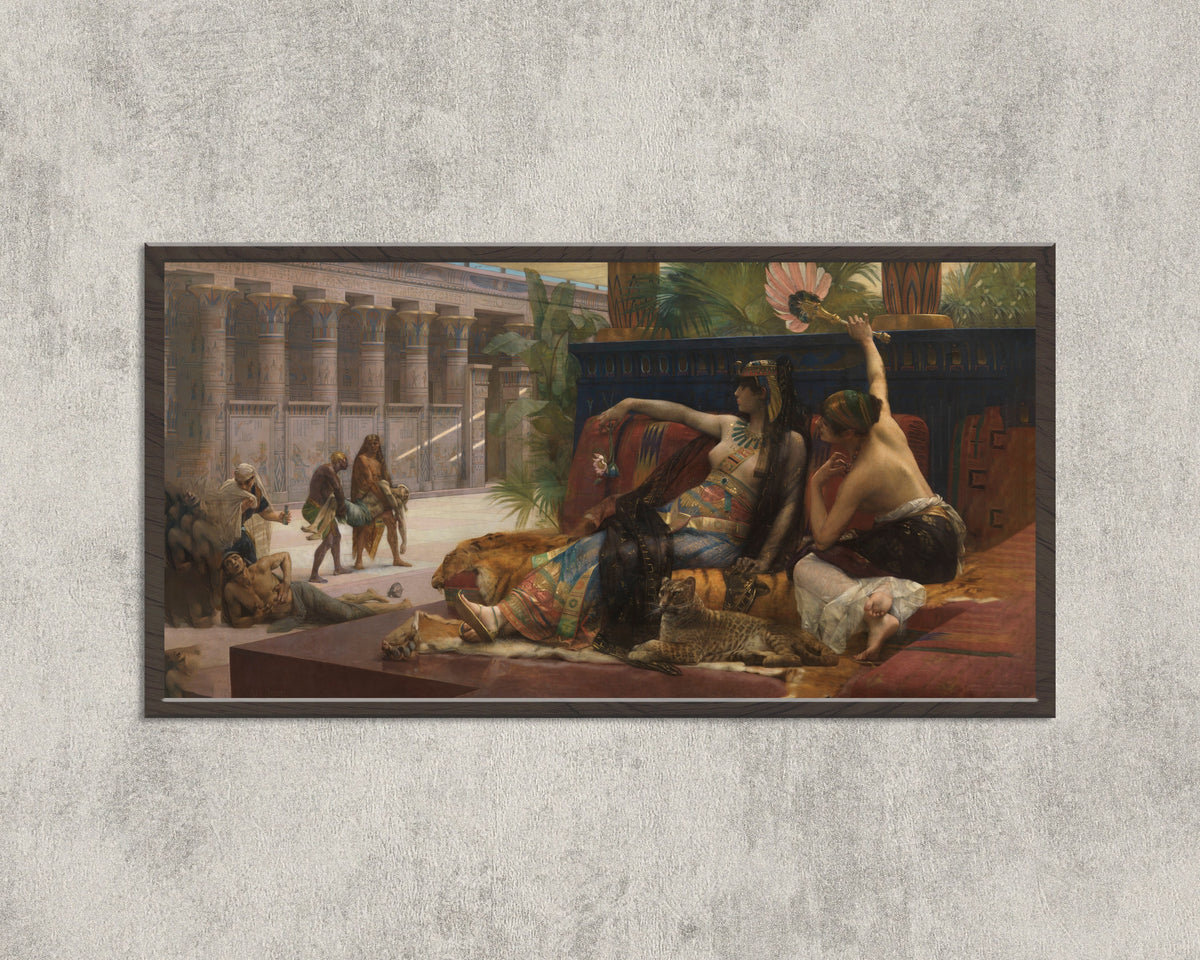Framed art print of Cleopatra Testing Poisons on Condemned Prisoners by Alexandre Cabanel, in a wide black frame on a concrete wall