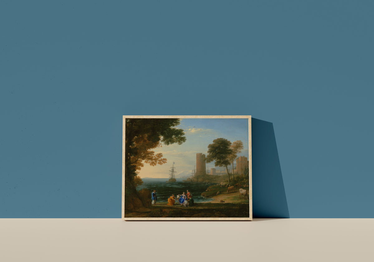 Framed art print of Coast View with the Abduction of Europa by Claude Lorrain, in a light wood frame leaning on a blue wall
