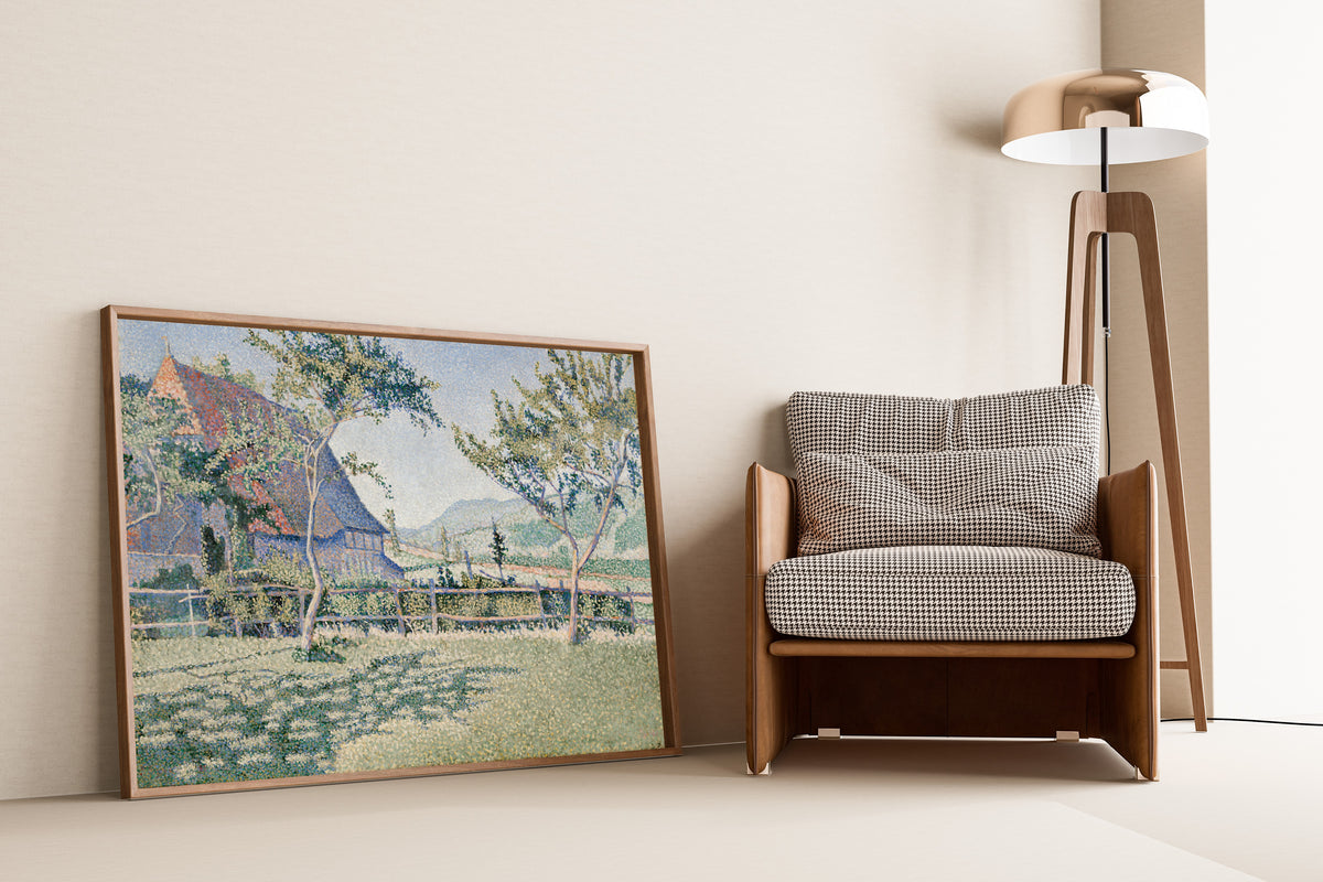 Framed art print of Comblat-le-Château, the Meadow by Paul Signac, leaning against a wall beside an armchair and a floor lamp