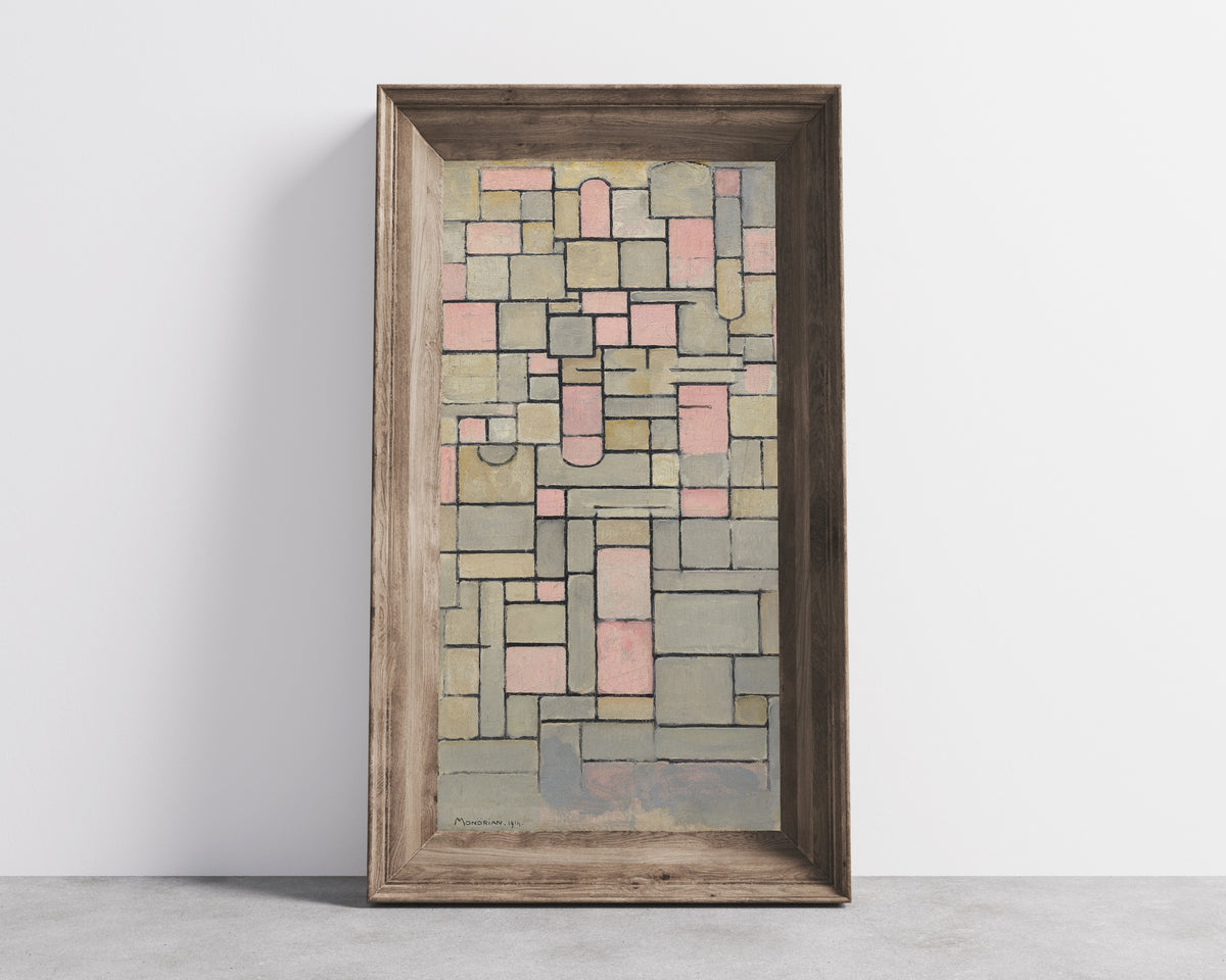 Framed art print of Composition 8 by Piet Mondrian, in a wide wooden frame leaning against a concrete wall