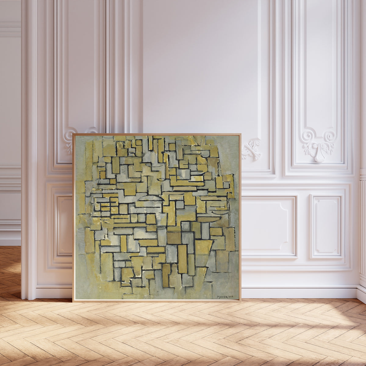Framed art print of Composition in Brown and Grey by Piet Mondrian, leaning against pale pink panelling on a herringbone floor