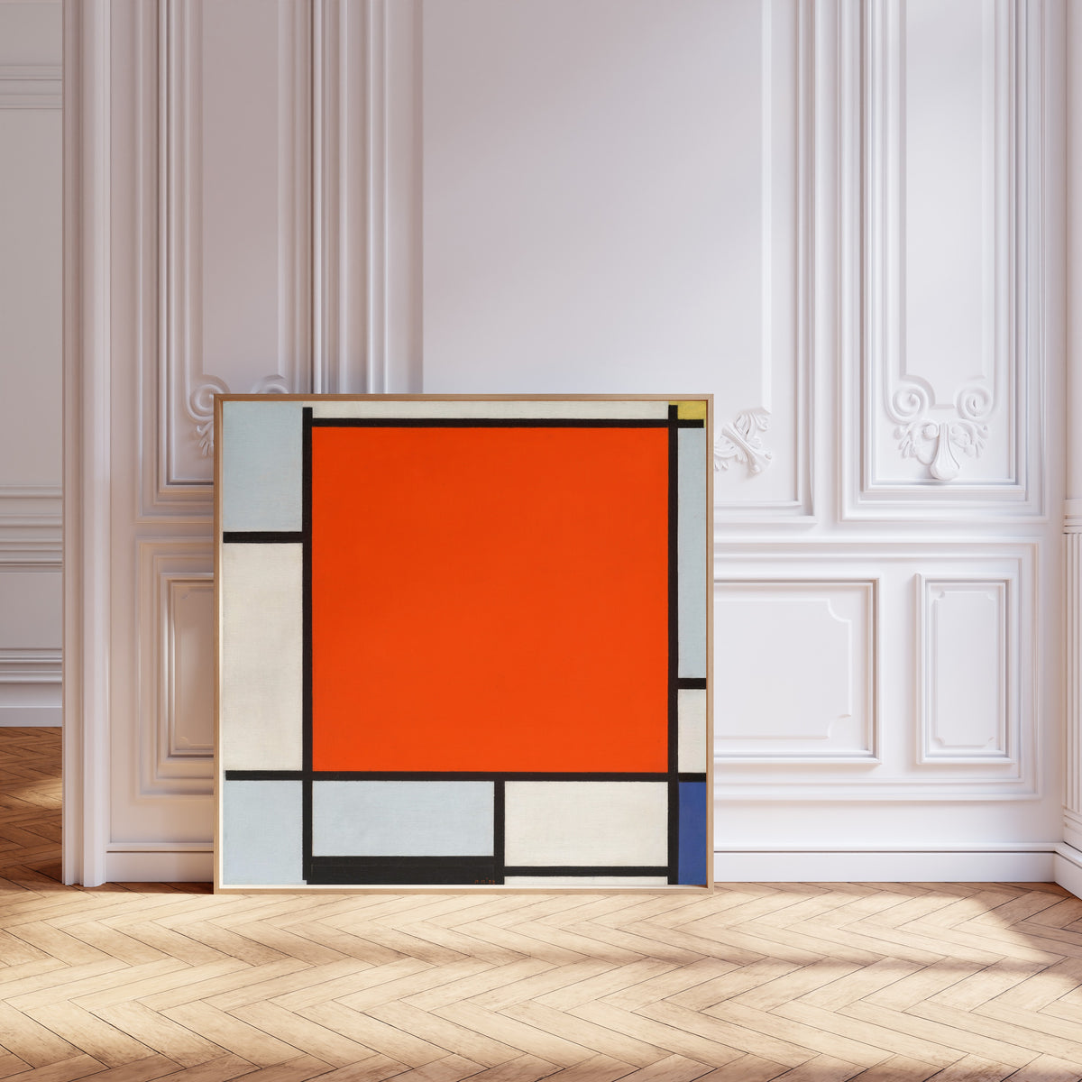 Framed art print of Composition with Large Red Plane, Bluish Gray, Yellow, Black… by Piet Mondrian, leaning against pale pink panelling on a herringbone floor