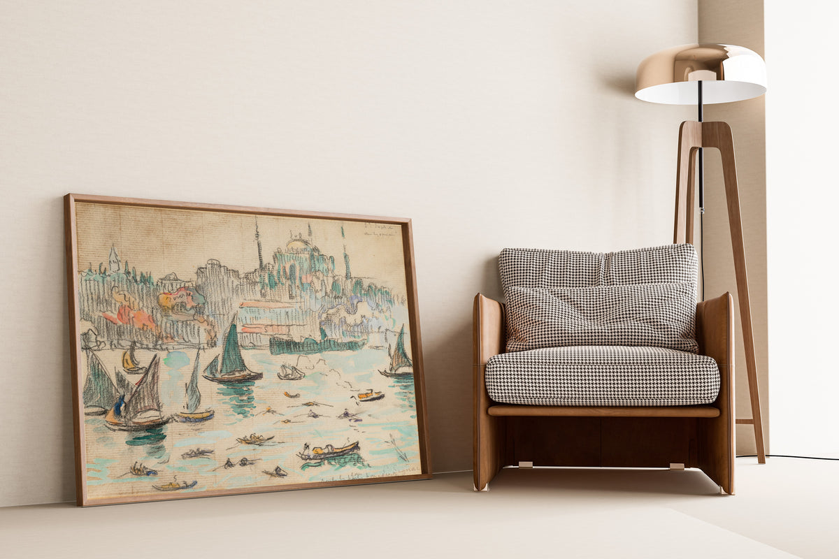 Framed art print of Constantinople, Sainte-Sophie by Paul Signac, leaning against a wall beside an armchair and a floor lamp