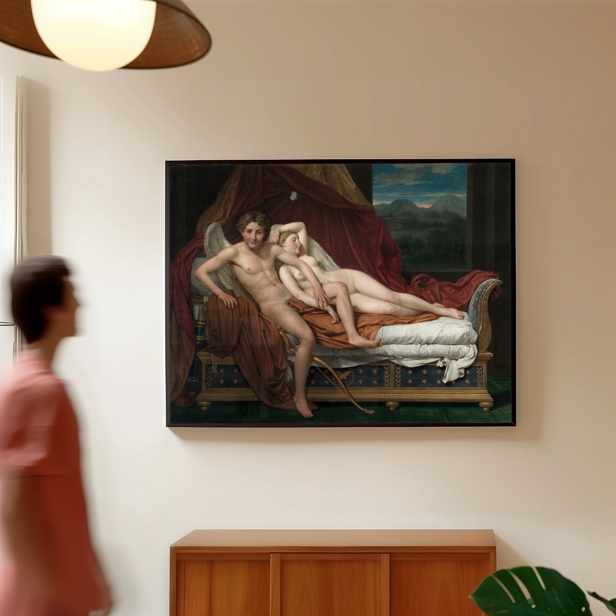 Framed art print of Cupid and Psyche by Jacques-Louis David, in a slim black frame on a warm wall in a sunlit room