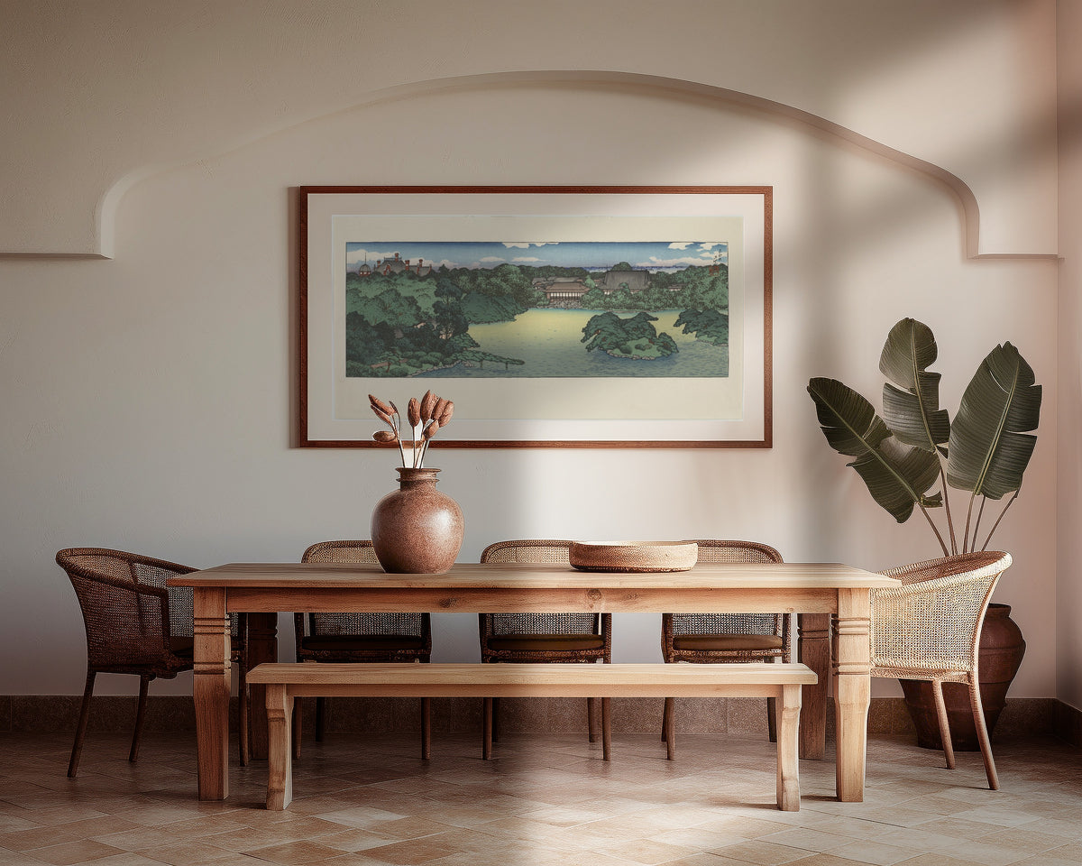 Framed art print of Daisensui Pond, Mitsubishi Villa at Fukagawa by Kawase Hasui, above a wooden dining table