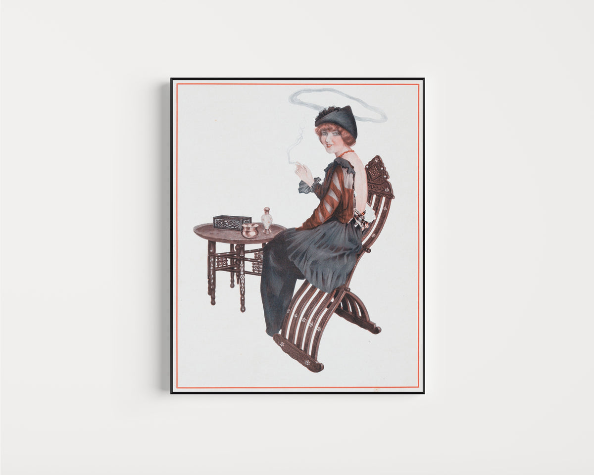 Framed art print of De la Brune à la Blonde, Pl. 4: L'Auréole de Sainte Nitouche by Raphael Kirchner, in a slim black frame on a plain white wall