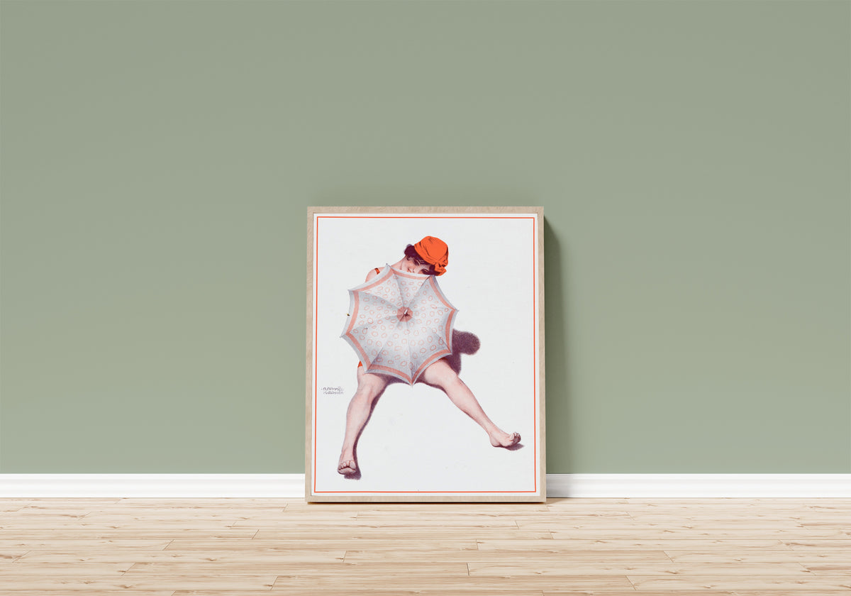 Framed art print of De la Brune à la Blonde, Pl. 5: Au Bord de la… by Raphael Kirchner, in a light wood frame leaning on a sage green wall above a wooden floor