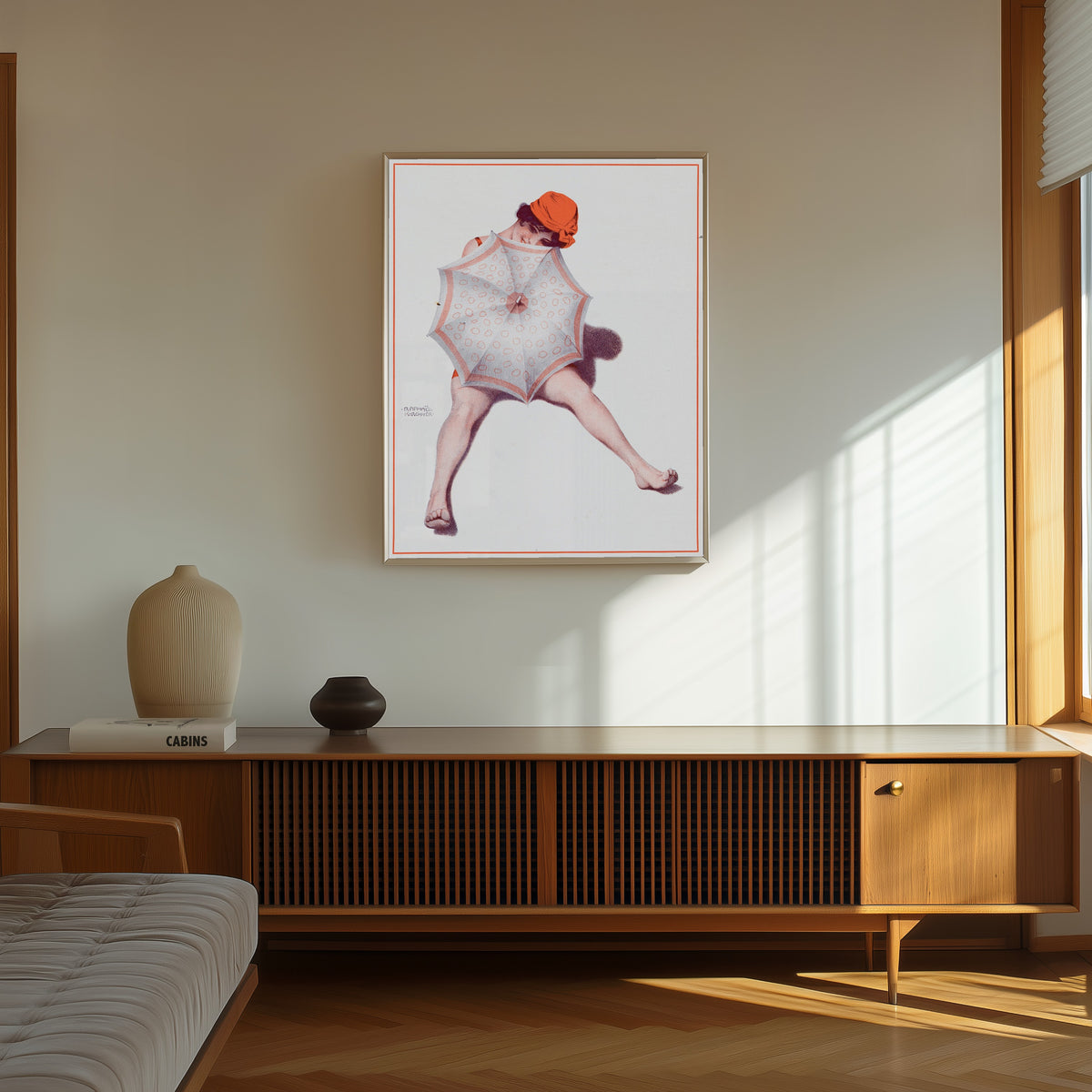 Framed art print of De la Brune à la Blonde, Pl. 5: Au Bord de la Mer by Raphael Kirchner, in a thin light frame on a sunlit wall above a wooden sideboard