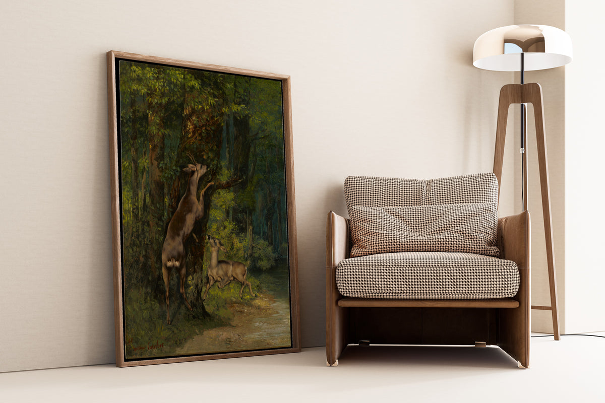 Deer in the Forest by Gustave Courbet — framed and leaning against a wall beside an armchair and a floor lamp
