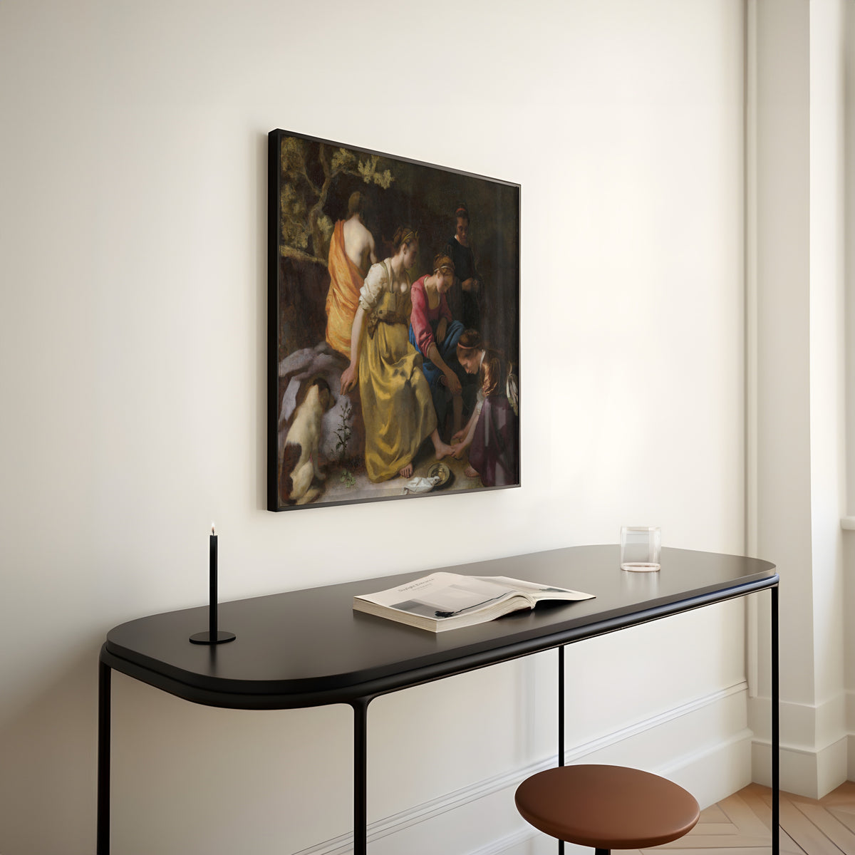 Framed art print of Diana and Her Nymphs by Johannes Vermeer, above a slim black console table