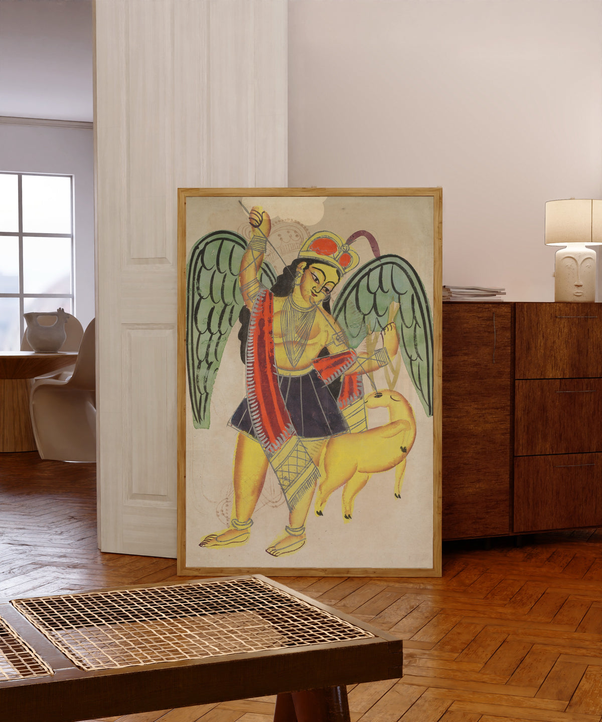 Framed art print of Diana or Artemis, Goddess of the Hunt by Kalighat painter, in a light wood frame leaning in a warm room with a parquet floor
