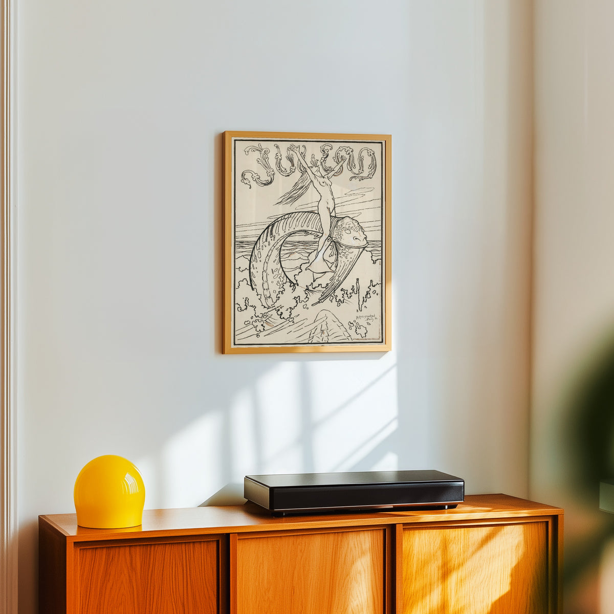 Framed art print of Die Woge by Hans Christiansen, in a light wood frame on a white wall above an orange sideboard