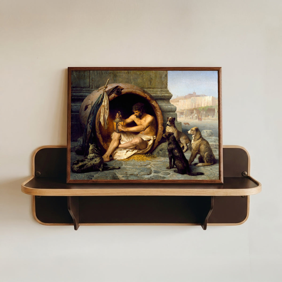 Framed art print of Diogenes by Jean-Léon Gérôme, in a dark wood frame resting on a wall shelf