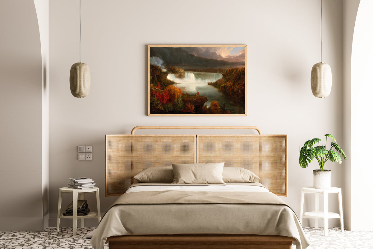 Distant View of Niagara Falls by Thomas Cole — framed above a cane-headboard bed