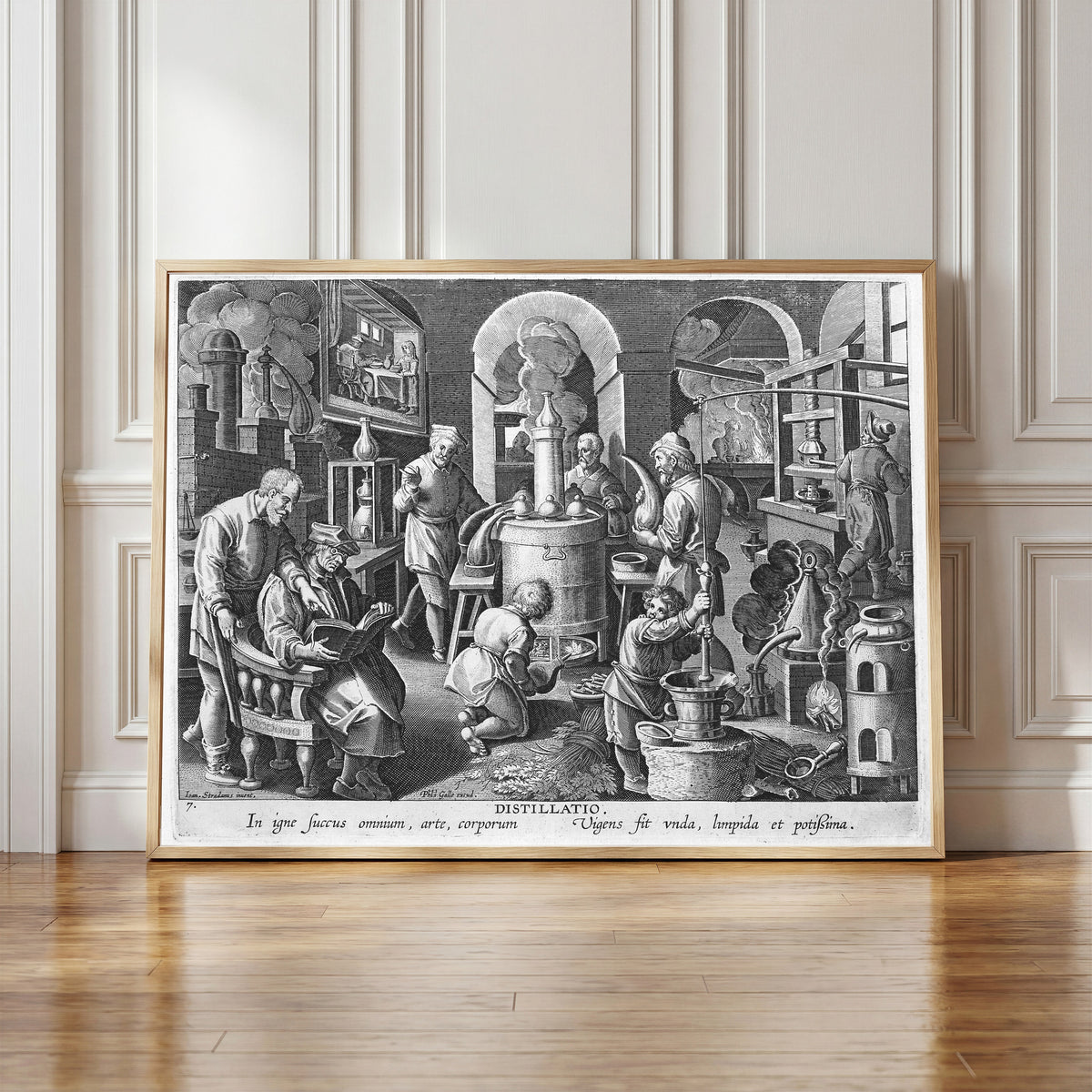 Framed art print of Distillatio: the Alchemist's… by Philips Galle after Jan van der Straet, in a light wood frame leaning against a panelled white wall