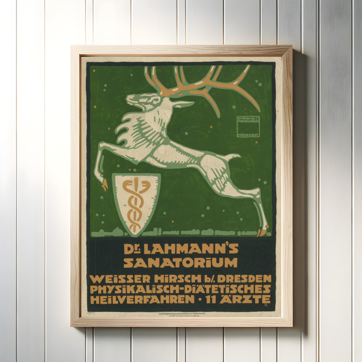 Framed art print of Dr. Lahmann's Sanatorium, Weisser Hirsch bei Dresden by Ludwig Hohlwein, in a light wood frame on a white panelled wall