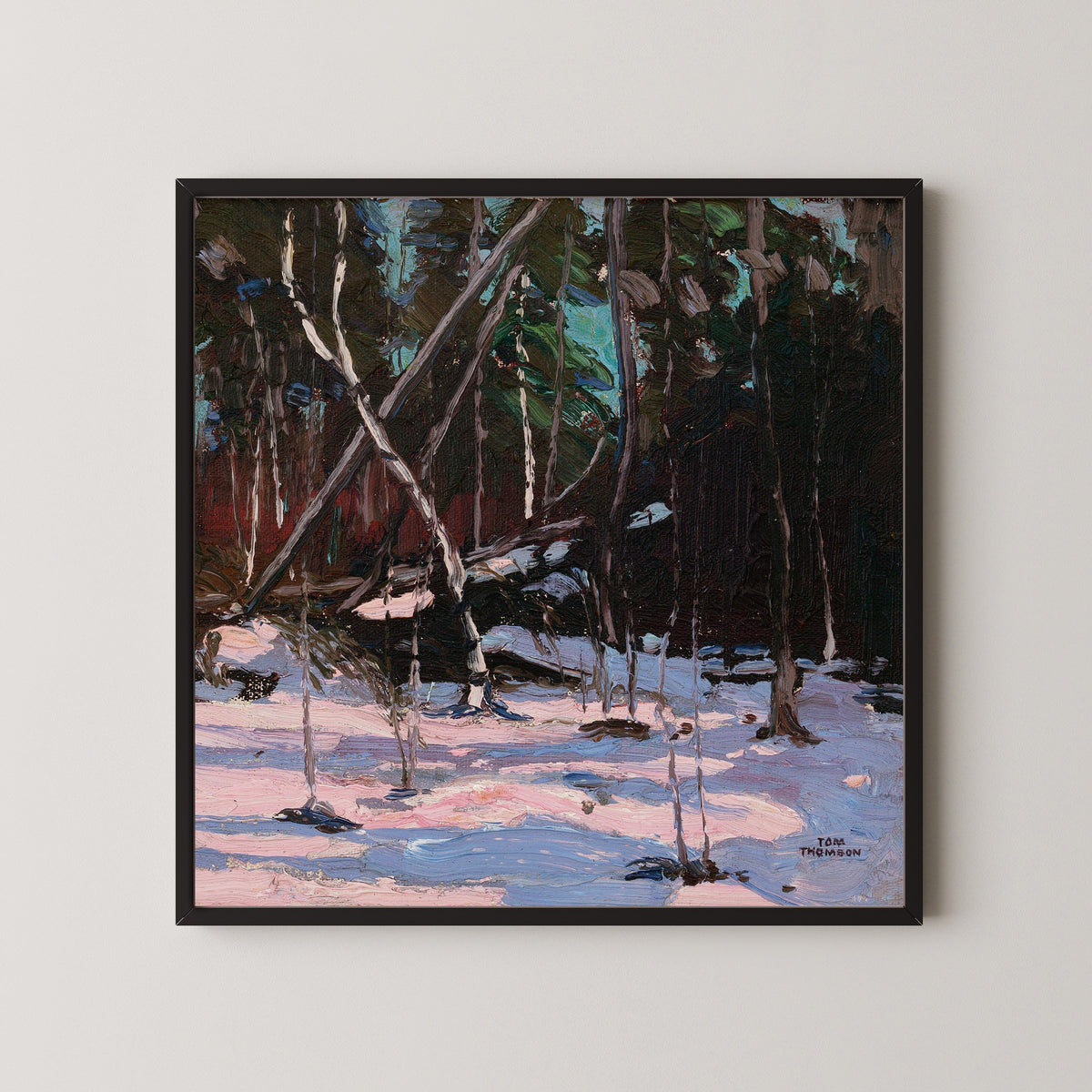 Framed art print of Early Snow, Algonquin Park by Tom Thomson, in a black frame on a pale wall