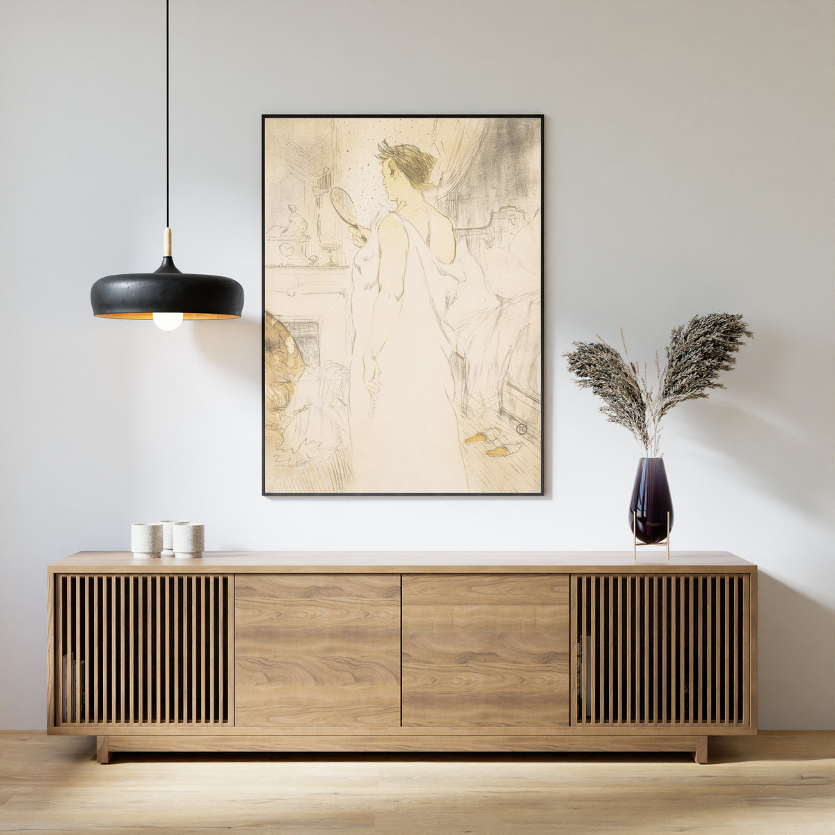 Framed art print of Elles: Woman with a Hand Mirror by Henri de Toulouse-Lautrec, above a slatted wood sideboard